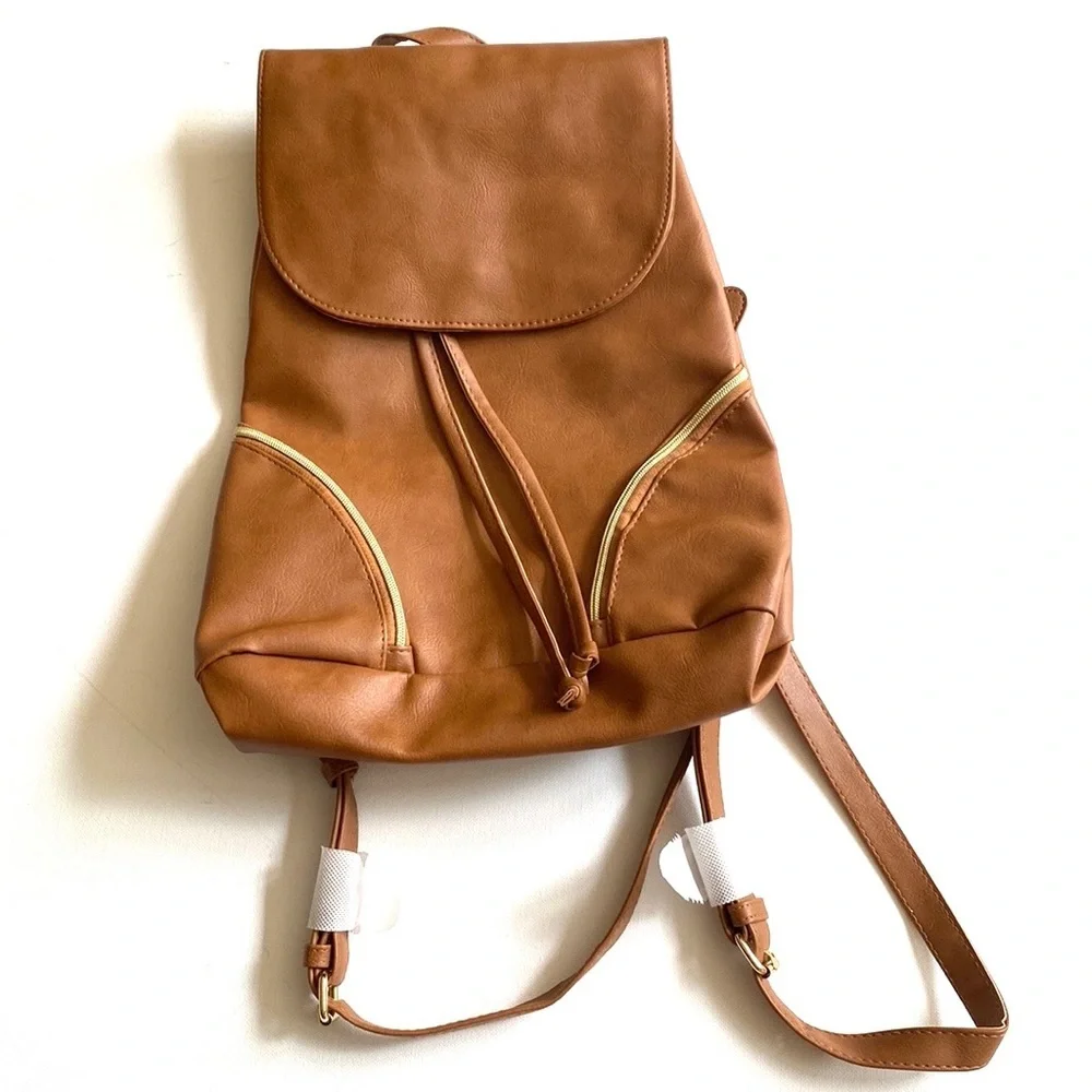 Brown backpack with zipper‎ accented detailing on front, NWOT